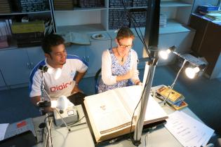 Library Assistant from National University of Samoa microfilming the Samoa Times with Kylie Moloney, former Pambu Executive Officer.