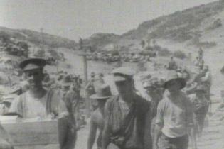 Men of the Australian forces make their way up “Monash Valley”, past the headquarters of Generals Monash and Chauvel.